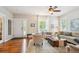 Open living room with hardwood floors, ceiling fan, and a view of the front entry at 2723 Galena St, Denver, CO 80238