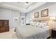 Comfortable main bedroom with neutral tones, tray ceiling, plush carpeting, and elegant furniture at 2723 Galena St, Denver, CO 80238