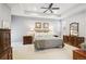 Spacious main bedroom with neutral tones, tray ceiling, plush carpet, and stylish decor at 2723 Galena St, Denver, CO 80238