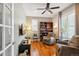 Charming office with hardwood floors, built-in shelving, and relaxing recliner seating at 2723 Galena St, Denver, CO 80238