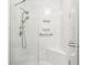 Contemporary shower featuring modern fixtures, a built-in seat, and sleek marble tiling at 2723 Galena St, Denver, CO 80238