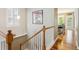 Stairway with hardwood steps, white banisters, and light neutral walls with modern decor at 2723 Galena St, Denver, CO 80238