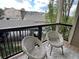 Balcony view with outdoor seating, railing and an overview of parking area and surrounding community at 7429 S Alkire St # 205, Littleton, CO 80127