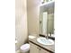 Neutral bathroom features a mirror, toilet, sink with countertop, and shower with glass doors and white curtain at 7429 S Alkire St # 205, Littleton, CO 80127