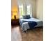 Bright bedroom features a bed with blue accents and a side table at 7429 S Alkire St # 205, Littleton, CO 80127