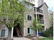 Condo exterior showing stone and siding, balcony and stairs leading to entrances and mature landscaping at 7429 S Alkire St # 205, Littleton, CO 80127