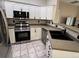 Kitchen features stainless appliances, light cabinets, and a dark sink with designer faucet at 7429 S Alkire St # 205, Littleton, CO 80127