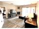 Bright living room with fireplace, sliding door to patio, wood-style flooring and a neutral color palette at 7429 S Alkire St # 205, Littleton, CO 80127