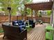 Inviting deck area featuring comfortable seating, a pergola, and outdoor heaters at 9807 Arthur Ln, Highlands Ranch, CO 80130