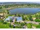 Aerial view featuring the community center, pool, parking lot, and scenic lake at 4461 Vrain St, Denver, CO 80212
