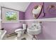 Bathroom with vintage fixtures, lilac walls, and natural light at 4461 Vrain St, Denver, CO 80212