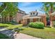 Quaint brick home with covered porch and inviting front yard landscaping at 4461 Vrain St, Denver, CO 80212