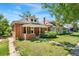 Brick home with covered front porch and green lawn at 4461 Vrain St, Denver, CO 80212