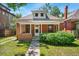 Charming brick home with a cozy front porch and well-maintained lawn at 4461 Vrain St, Denver, CO 80212