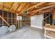 Unfinished interior view of one-car garage with exposed beams and concrete floor at 4461 Vrain St, Denver, CO 80212