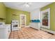 Kitchen showcasing tile flooring, white cabinets, and natural light at 4461 Vrain St, Denver, CO 80212