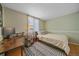 Bright bedroom with a double bed, desk, and wood floors at 9336 Pierce St, Westminster, CO 80021