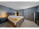 Serene bedroom with a wood bed frame and neutral carpeting at 9336 Pierce St, Westminster, CO 80021