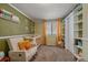 Bedroom with crib, rocking chair, and built-in shelves at 9336 Pierce St, Westminster, CO 80021