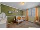 Bedroom with crib, rocking chair, and built-in shelves at 9336 Pierce St, Westminster, CO 80021