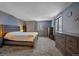 Primary bedroom with wood bed frame, dresser, and neutral carpeting at 9336 Pierce St, Westminster, CO 80021