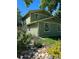 Two story green house with landscaping and a metal fence at 9336 Pierce St, Westminster, CO 80021