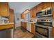 Functional kitchen featuring stainless steel appliances and wood cabinets at 9336 Pierce St, Westminster, CO 80021