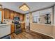 Kitchen with stainless steel appliances, wood cabinets, and view into dining area at 9336 Pierce St, Westminster, CO 80021