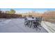 Concrete backyard patio with metal table and chairs, and metal perimeter fence at 25123 E 5Th Ave, Aurora, CO 80018