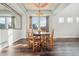 Formal dining room featuring hardwood floors, chandelier, and large window for natural light at 25123 E 5Th Ave, Aurora, CO 80018