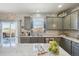 Bright kitchen featuring stainless steel appliances, gray cabinets, stone countertops and a sliding glass door at 25123 E 5Th Ave, Aurora, CO 80018