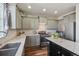 Well-lit kitchen features stainless steel appliances, gray cabinets, stone countertops, and a stylish backsplash at 25123 E 5Th Ave, Aurora, CO 80018