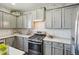 Modern kitchen featuring stainless steel appliances, gray cabinetry, and light countertops at 25123 E 5Th Ave, Aurora, CO 80018