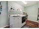 Functional laundry room with modern washer and dryer, ample storage, and stylish flooring at 25123 E 5Th Ave, Aurora, CO 80018