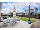 Backyard with patio set, lights and a dark-stained wood fence at 26787 E Maple Ave, Aurora, CO 80018