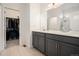 Bathroom featuring a double vanity, walk-in closet, shower and tile flooring at 26787 E Maple Ave, Aurora, CO 80018