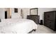 Comfortable bedroom with neutral tones, a large dresser, and ample natural light creating a cozy retreat at 26787 E Maple Ave, Aurora, CO 80018