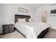Cozy bedroom with a dark wood bed frame, soft bedding, and tasteful decor creating a relaxing ambiance at 26787 E Maple Ave, Aurora, CO 80018