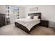 Inviting bedroom featuring a dark wood bed frame, soft lighting, and a calming atmosphere at 26787 E Maple Ave, Aurora, CO 80018