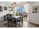 Bright dining room featuring modern table and chairs with sliding glass door to backyard at 26787 E Maple Ave, Aurora, CO 80018