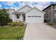 Charming home featuring a landscaped front yard, two-car garage, and a welcoming covered porch at 26787 E Maple Ave, Aurora, CO 80018