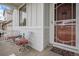 Inviting front porch with seating area, charming decor, and a view of the neighborhood at 26787 E Maple Ave, Aurora, CO 80018