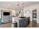 Open kitchen with a large island, granite countertops, pendant lighting, and seamless flow into the living room at 26787 E Maple Ave, Aurora, CO 80018