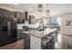 Modern kitchen featuring gray cabinets, granite countertops, stainless steel appliances, and stylish lighting at 26787 E Maple Ave, Aurora, CO 80018