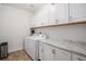 Laundry room with a utility sink, counter and cabinetry at 26787 E Maple Ave, Aurora, CO 80018