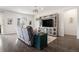 Cozy living room featuring wood floors, a comfortable couch, and entertainment center at 26787 E Maple Ave, Aurora, CO 80018