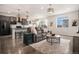 Open-concept living space with modern finishes, stylish furniture, and plenty of natural light at 26787 E Maple Ave, Aurora, CO 80018