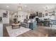 Bright open floor plan showcasing wood flooring connecting the living room, dining area, and kitchen at 26787 E Maple Ave, Aurora, CO 80018