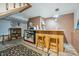 Basement bar area with wood counters, barstools, shelving, and an beverage refrigerator at 12173 W 27Th Dr, Lakewood, CO 80215