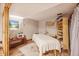 Bright basement room with storage shelves, a massage table, and a landscape painting at 12173 W 27Th Dr, Lakewood, CO 80215